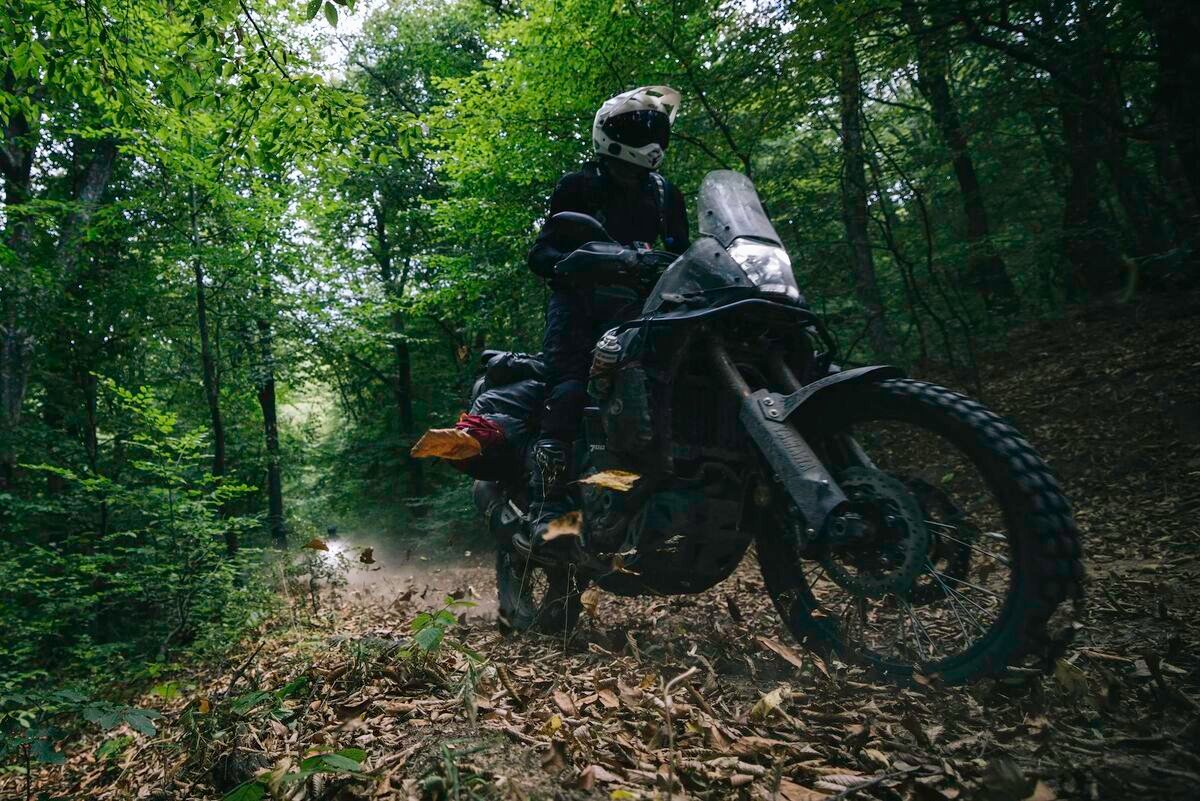 Adventure motorcycle riding through rugged terrain