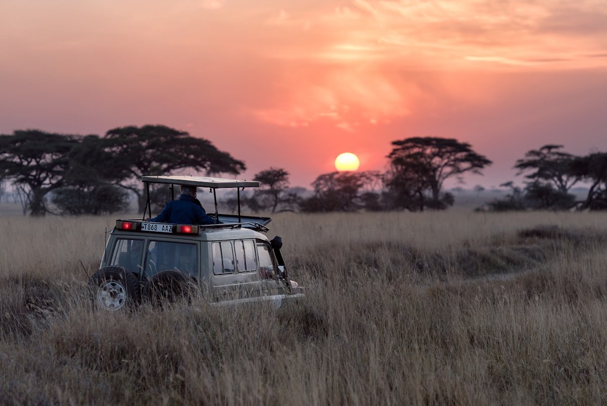 Tanzania motorcycle safari — riding across the African savanna with Kilimanjaro in the background